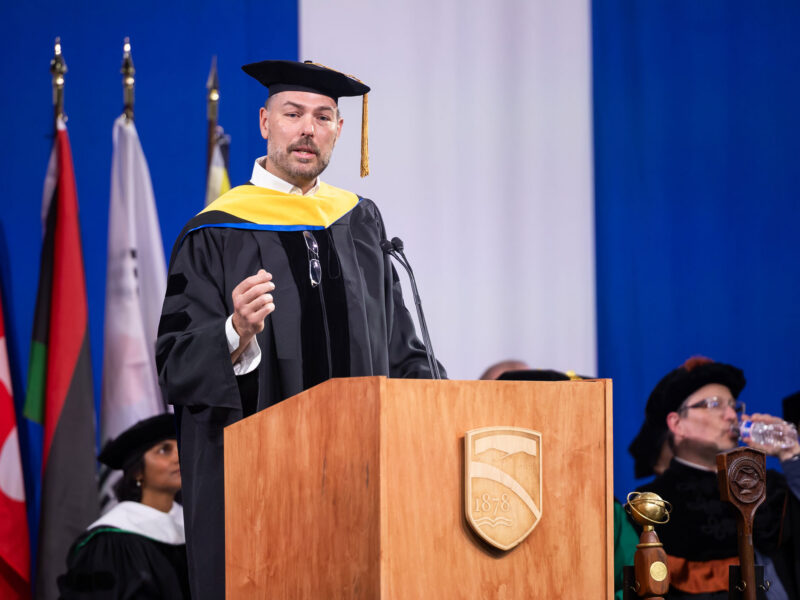 Kyle Clark delivering the commencement address for Champlain College in 2026